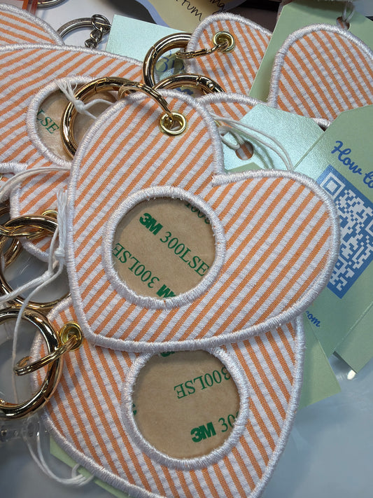 Peach and white striped fabric keychains with gold rings