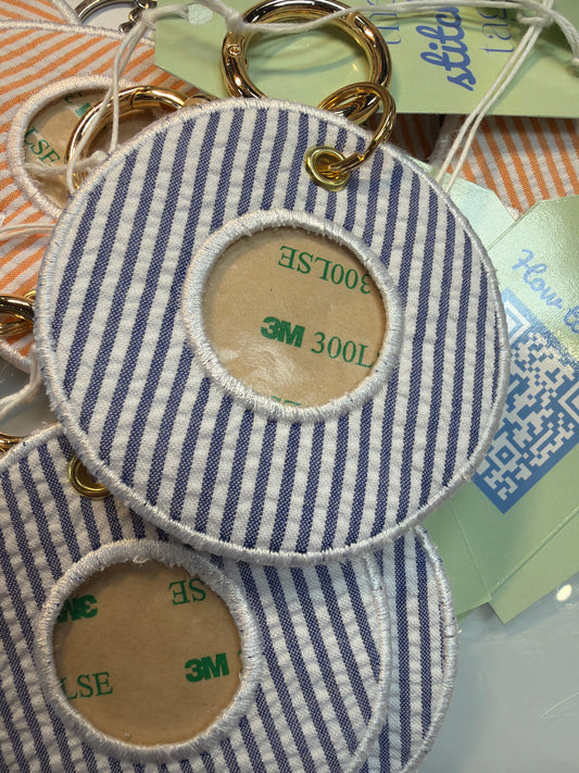 Round blue and white striped fabric tags with gold rings