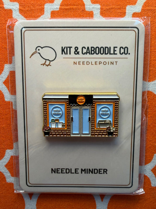 Kit & Caboodle Co. needle minder on orange patterned fabric