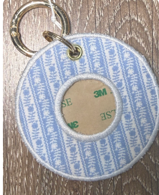 Round fabric keychain tag with blue and white pine tree pattern