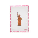 Cross-stitched design of the Statue of Liberty on fabric with 'what's the stitch' branding.