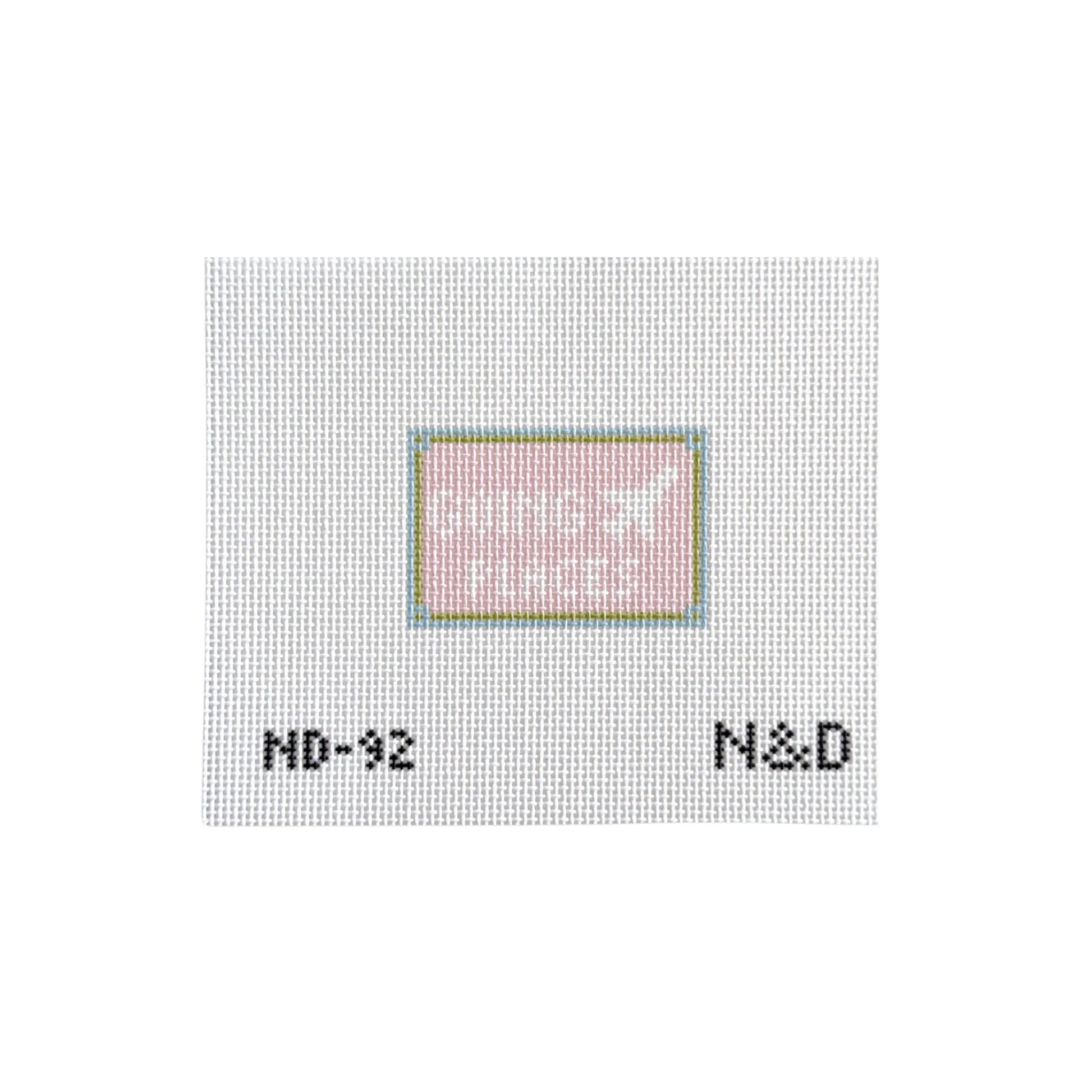 Textured white surface with a small square inset and text 'N&D' at the bottom.