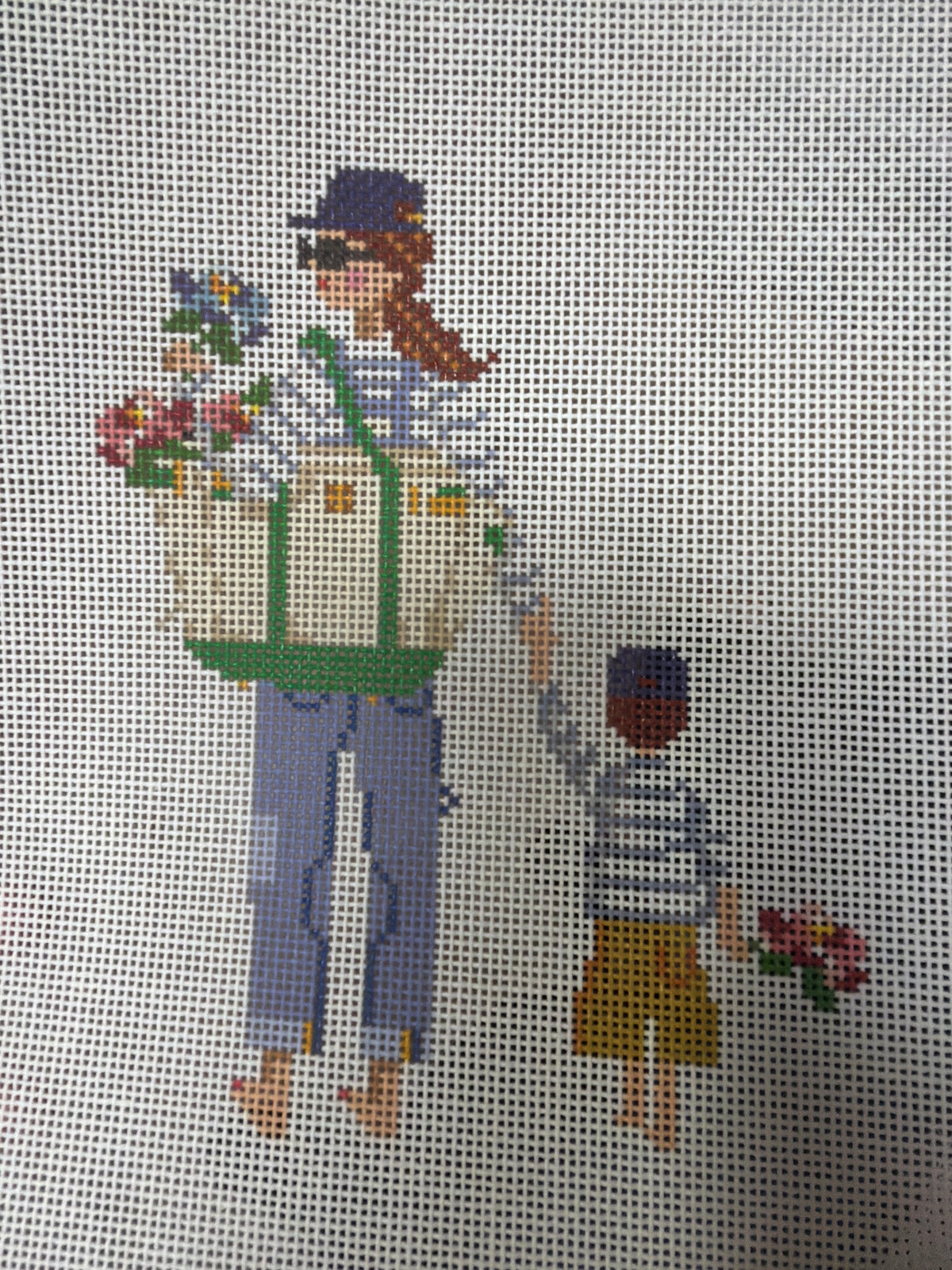 Woman carrying flower basket and holding hands with child