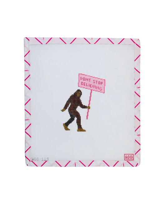 Notebook with a Sasquatch holding a 'Don't Stop Believing' sign on a white background
