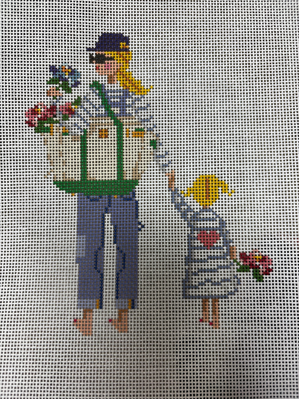 Woman carrying flowers and holding hands with a child