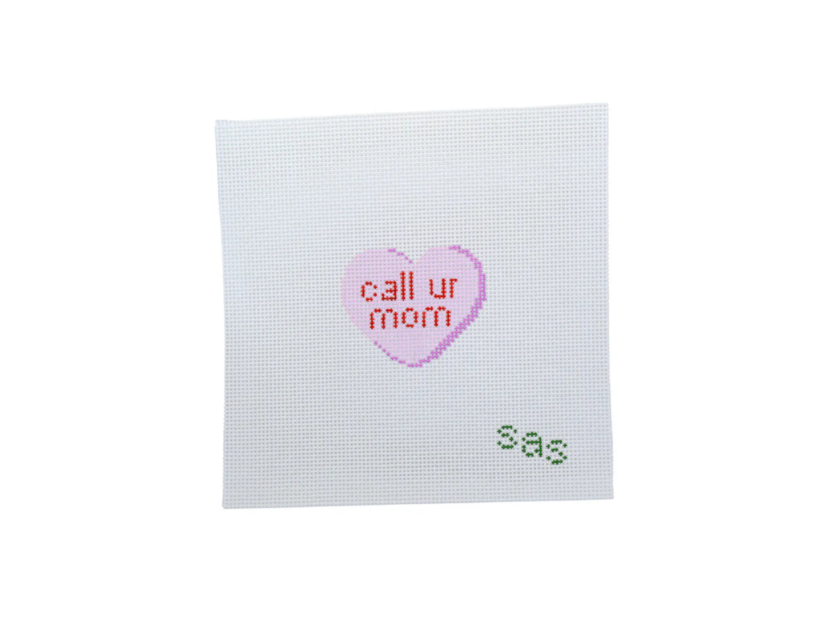 Cross-stitched heart with 'call ur mom' text on a white background