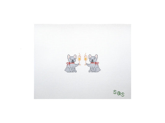 Cross-stitched design of two dogs holding champagne glasses with 'sas' text on a white background