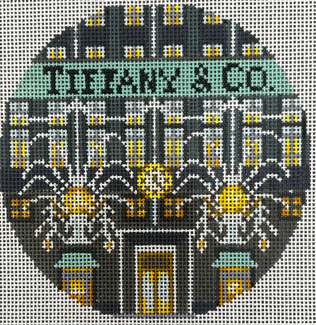 Decorative needlepoint design with 'Tiffany & Co.' branding and intricate patterns.