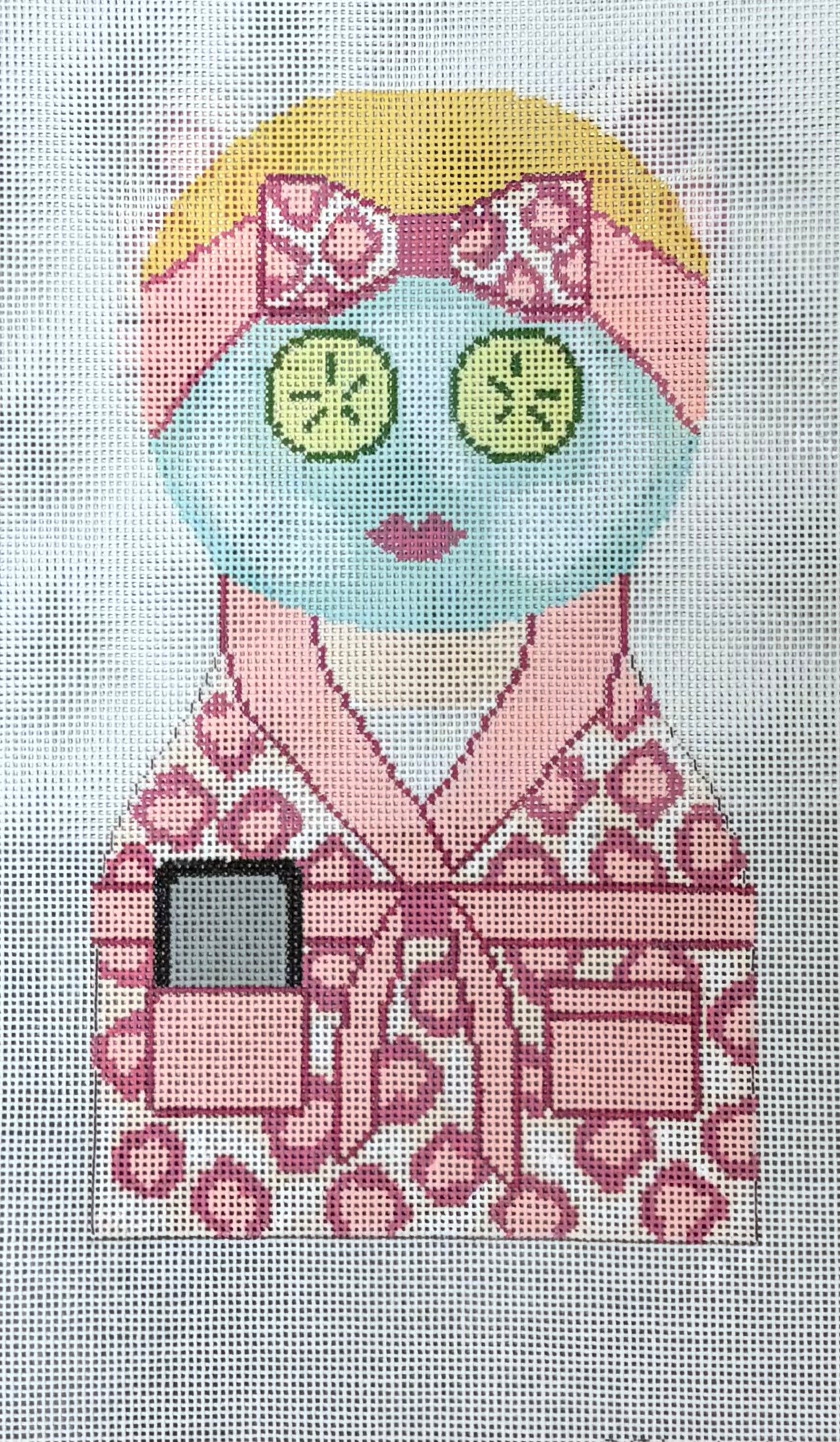Spa woman with cucumber slices, pink robe, and yellow headband