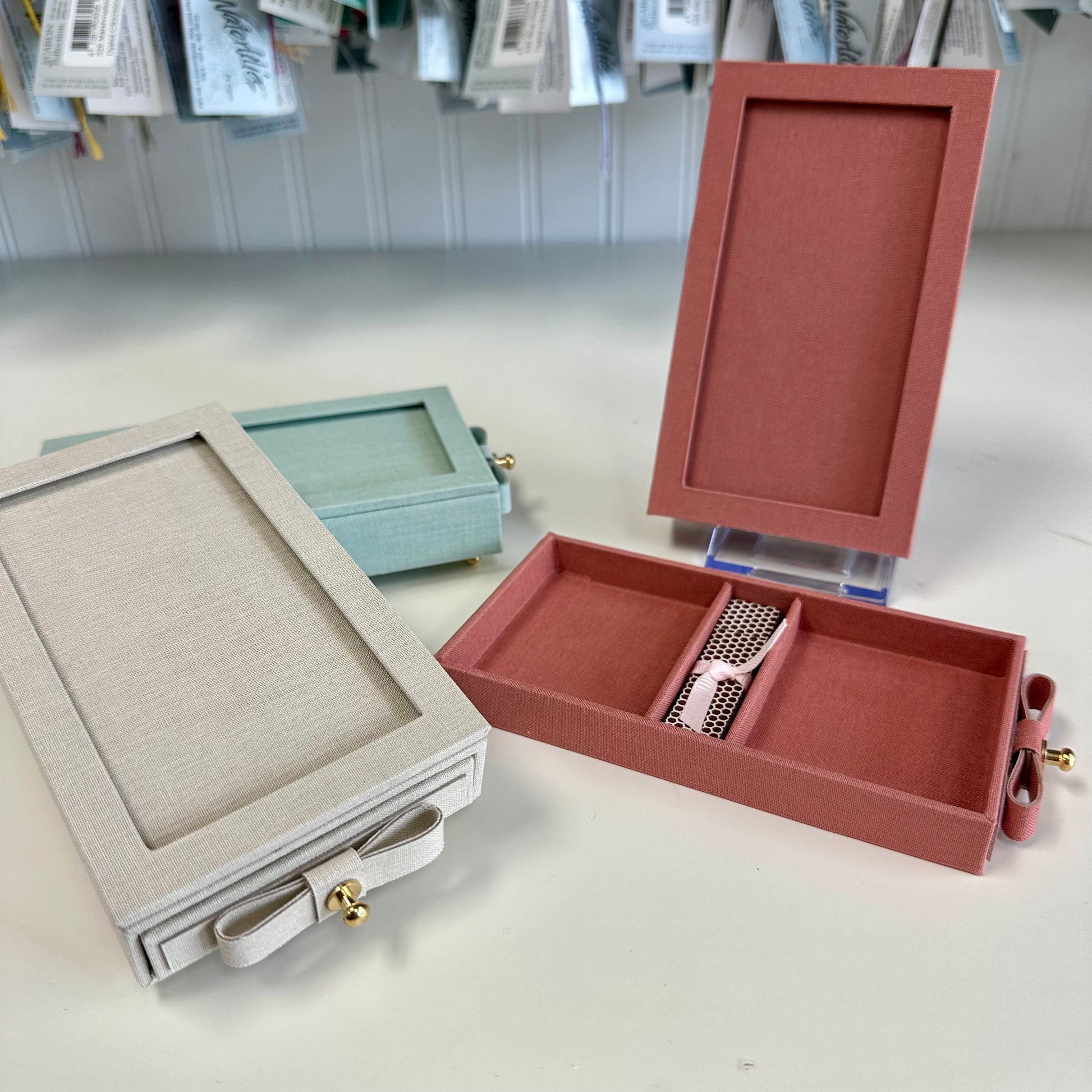 Jewelry boxes in various colors on a white surface