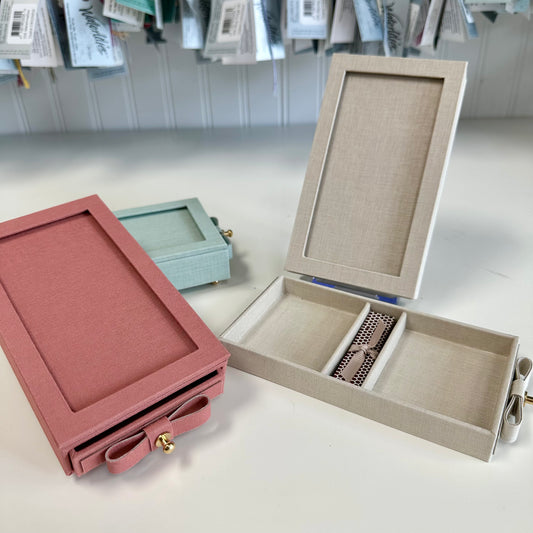 Jewelry boxes in various colors on a light surface with a blurred background