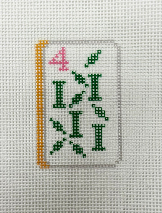 Cross-stitched design on fabric with green letters and pink number '4'