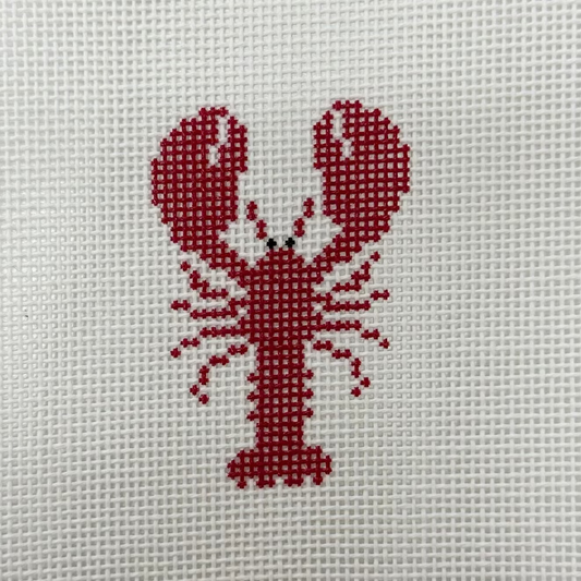 Cross-stitched red lobster on a white fabric background