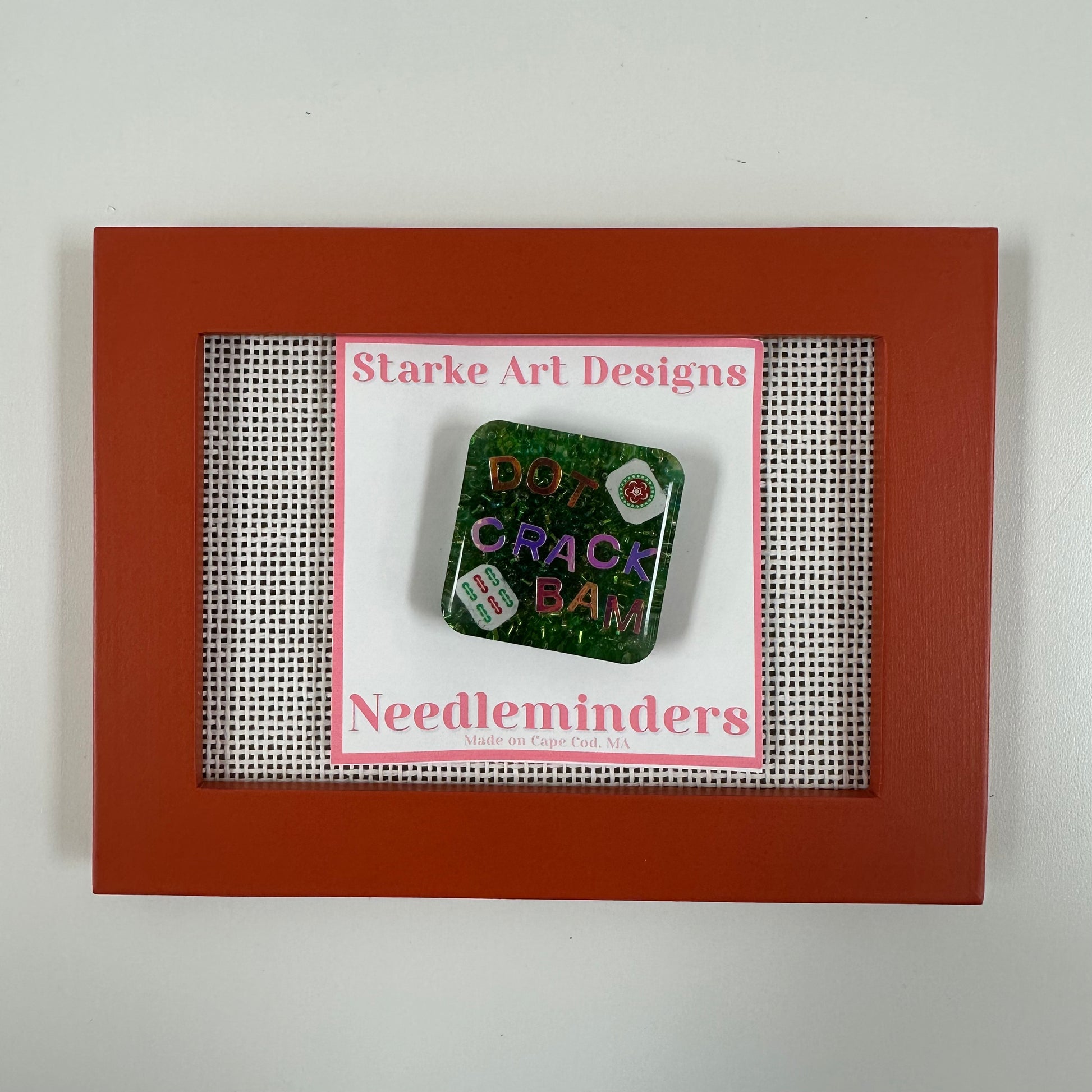 Square needle minder with text in a red frame, featuring 'Starke Art Designs'.