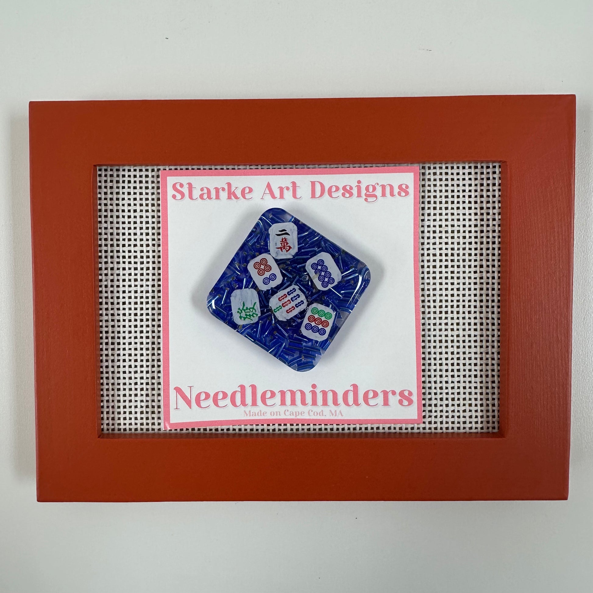 Set of blue needleminders in a red frame with 'Starke Art Designs' branding.