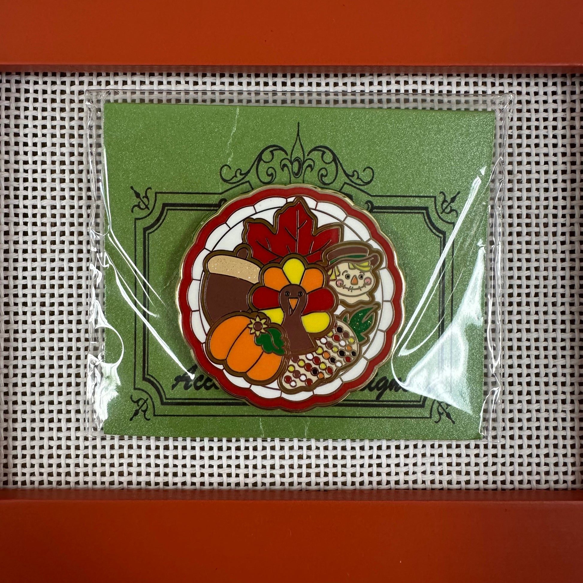 Decorative patch with a turkey, pumpkins, and leaves on a green background, framed in red.