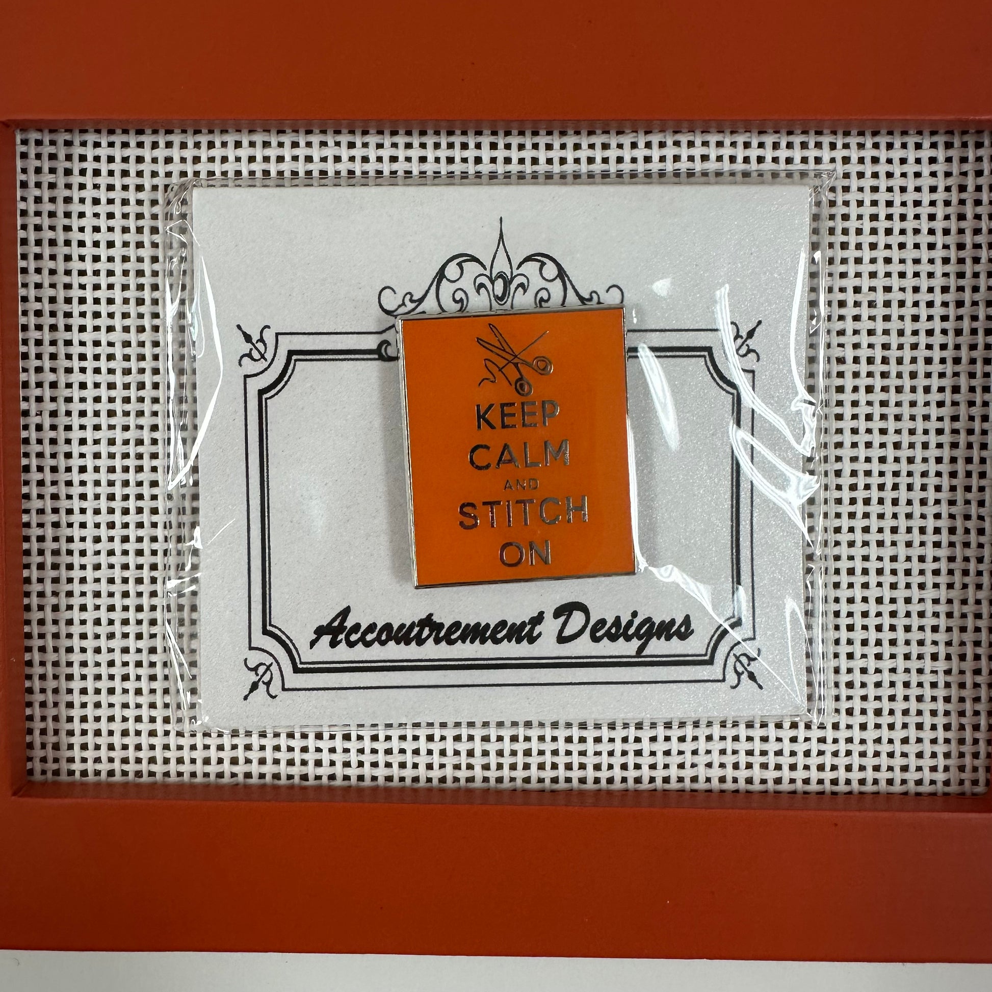 Packaged product with 'Keep Calm and Stitch On' text on a cross-stitch background