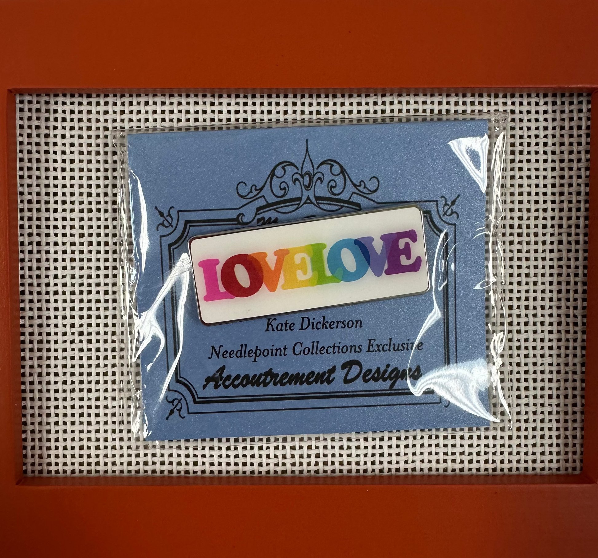 Packaged needlepoint kit with 'LOVE' label on a red frame