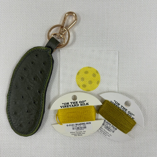 Black leather keychain with gold clasp, yellow thread spool, with 'On the Go' Vineyard Silk labels.