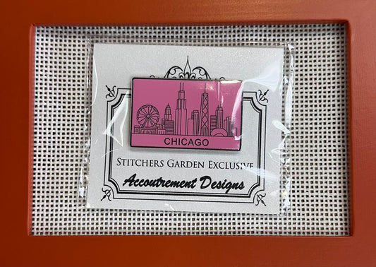 Packaged needlepoint product with 'Chicago' design on a grid background