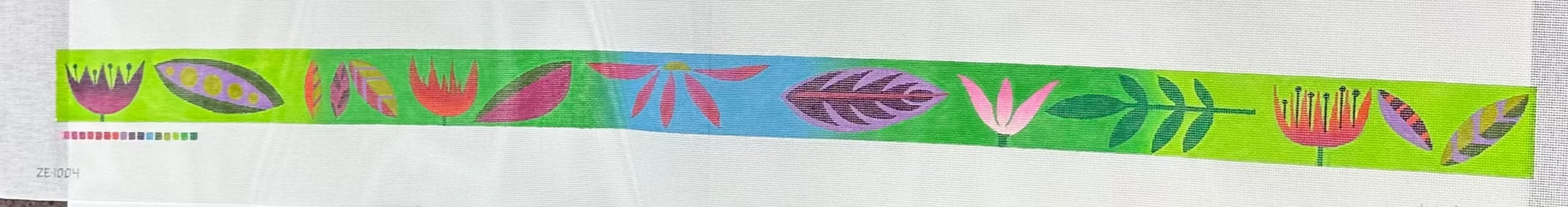 Decorative ribbon with colorful leaf pattern on a green background