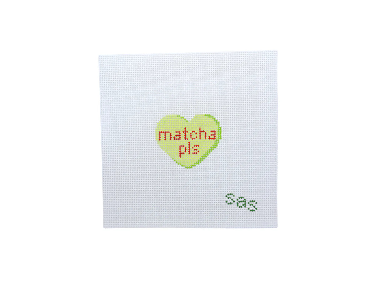 Cross-stitched heart with 'matcha pls' text on a white background