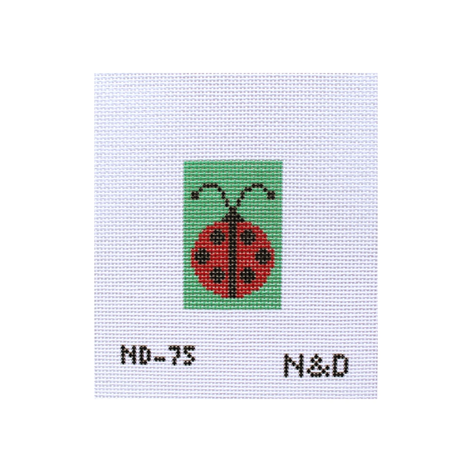 Cross-stitched ladybug design on fabric with 'ND-75' and 'N&D' text.