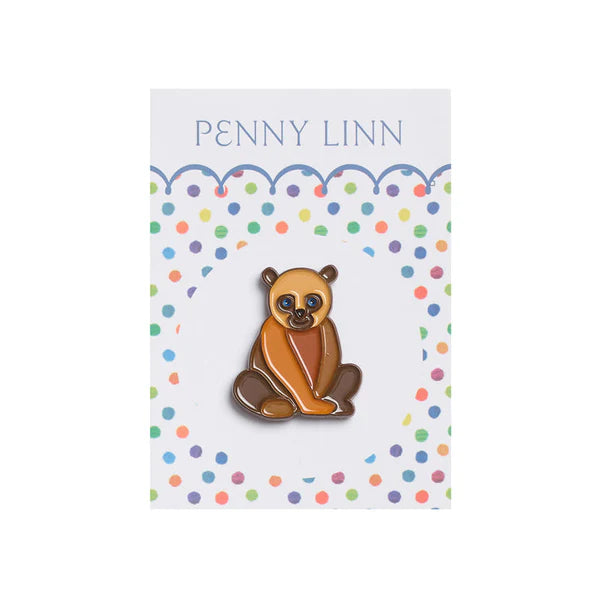 Polar bear pin on a colorful polka dot card with 'Penny Linn' branding