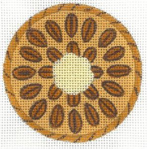 Round coaster with a sunflower design made of brown seeds on a beige background