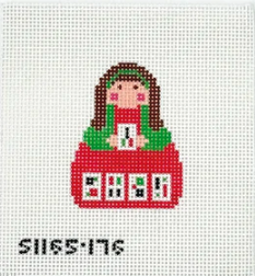 Cross-stitched design of a gingerbread house with a girl on a white background