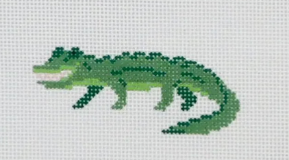 Cross-stitched green alligator on a white background