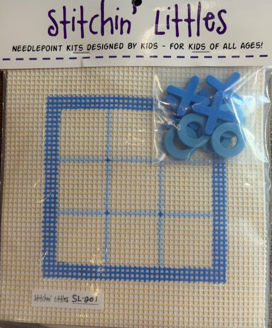 Needlepoint kit with blue plastic mesh and blue plastic cross-stitch markers, branded 'Stitchin' Littles'.