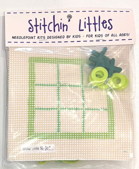 Stitchin' Littles needlepoint kit with green cross-stitch design and accessories on a white background.