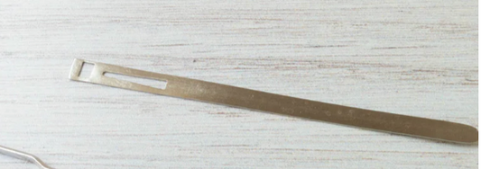 Metal strap on a light wooden surface