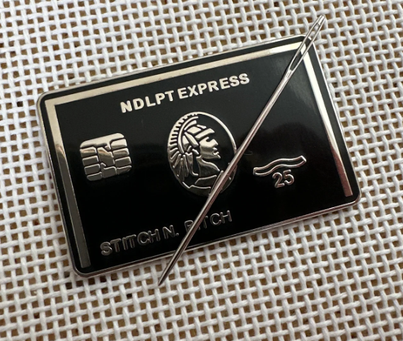 Metallic badge with 'NDLPT EXPRESS' and 'Stitch N Patch' branding on a textured background