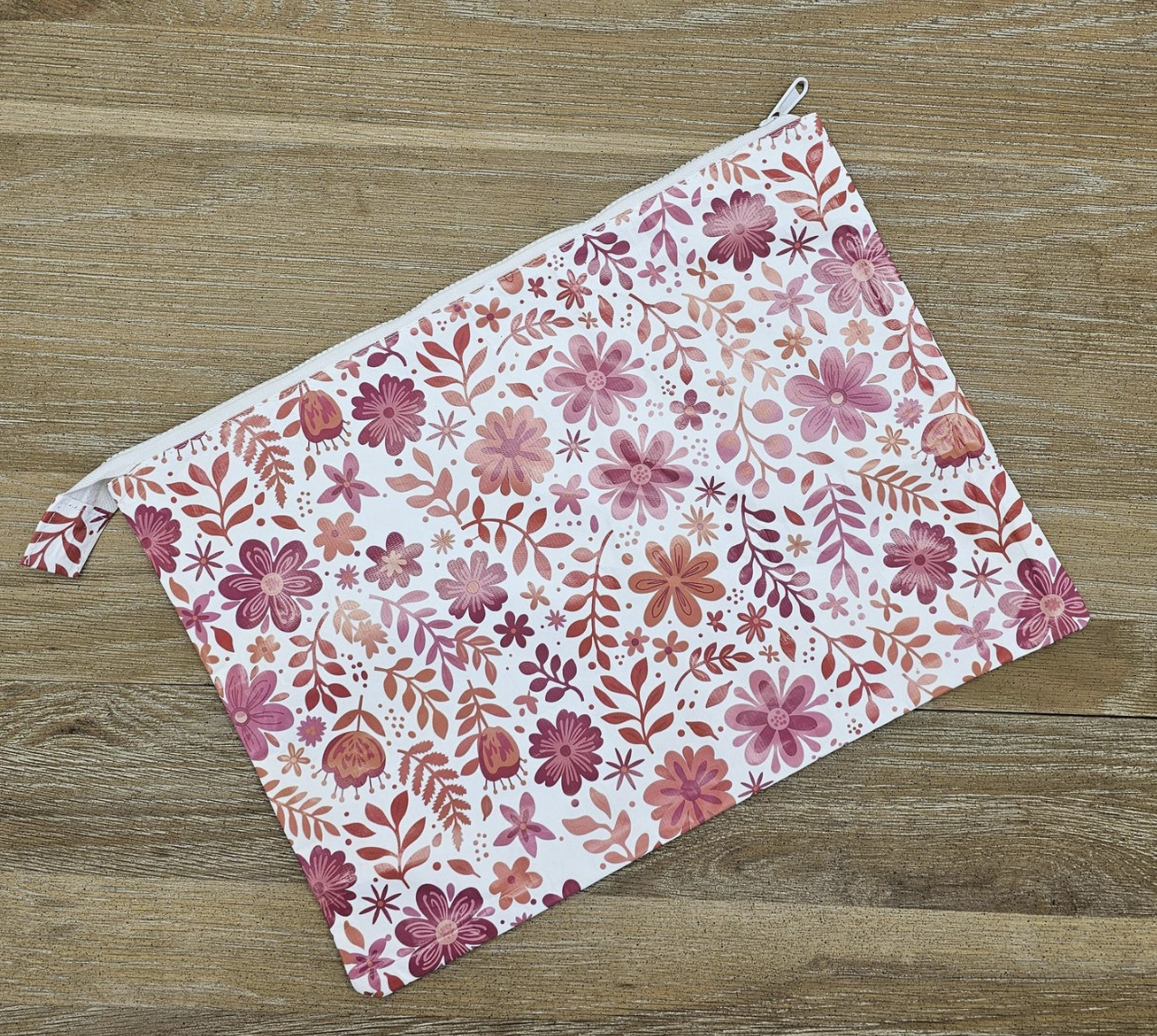 Floral-patterned pouch on a wooden surface