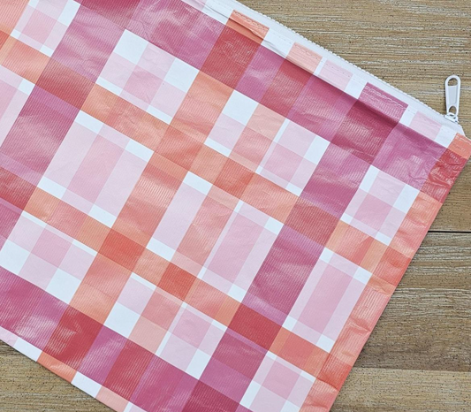 Pink and white checkered fabric on a wooden surface