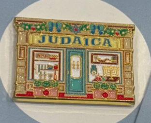 Decorative patch with 'Judaica' design featuring a store front.