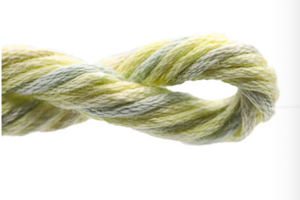 Close-up of a skein of green and gray yarn on a white background