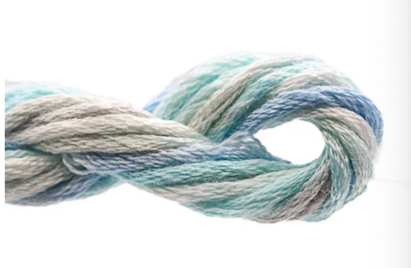 Coiled skein of yarn with blue and gray tones on a white background