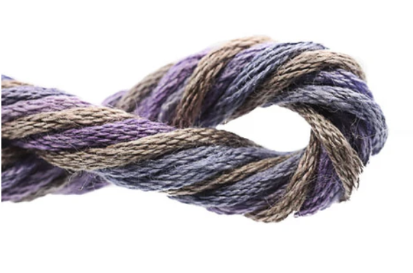 Coiled skein of purple and brown yarn on a white background
