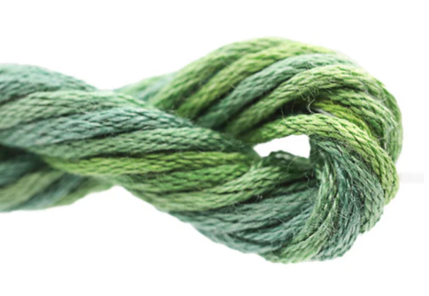 Close-up of green yarn tied in a knot on a white background