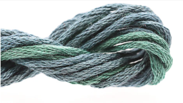 Close-up of green embroidery floss on a white background