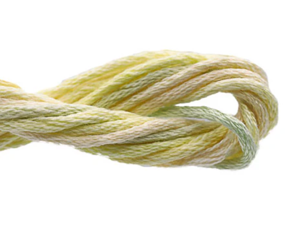 Close-up of yellow and green embroidery floss on a white background