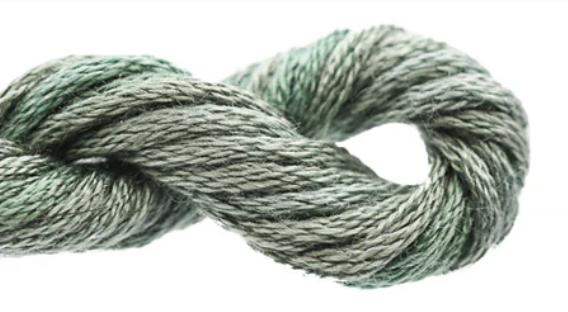 Coiled skein of green yarn on a white background