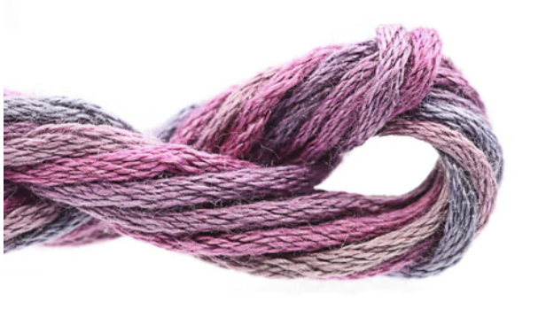 Close-up of pink and gray yarn on a white background