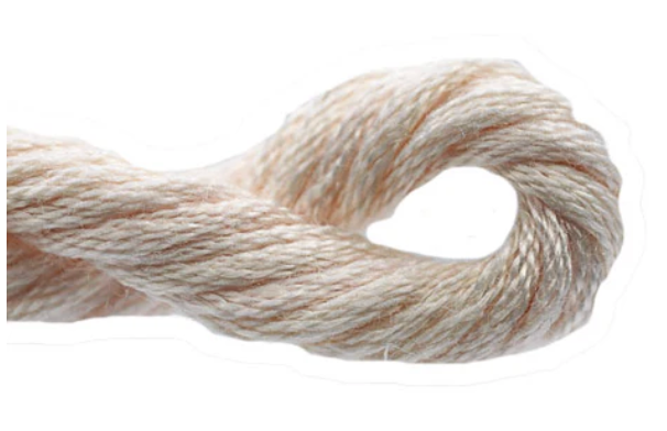 Close-up of a skein of beige yarn on a white background
