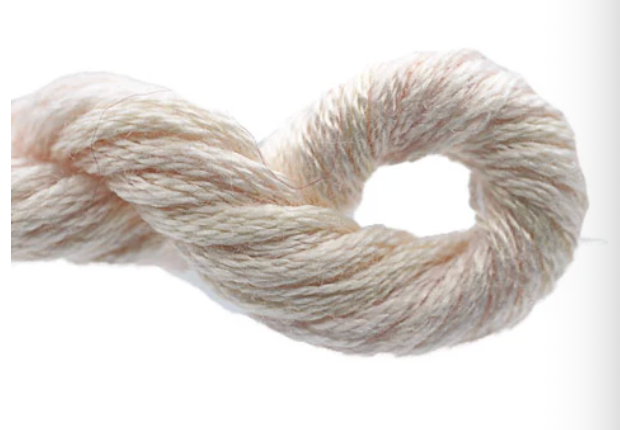 Ball of cream-colored yarn on a white background