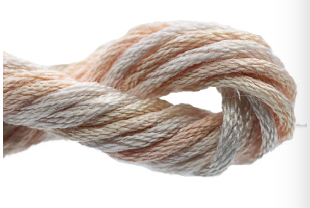 Close-up of a skein of beige and white yarn on a white background