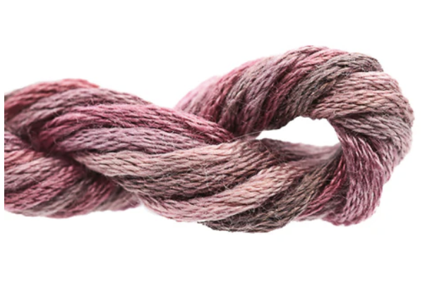 Twisted skein of pink and gray yarn on a white background